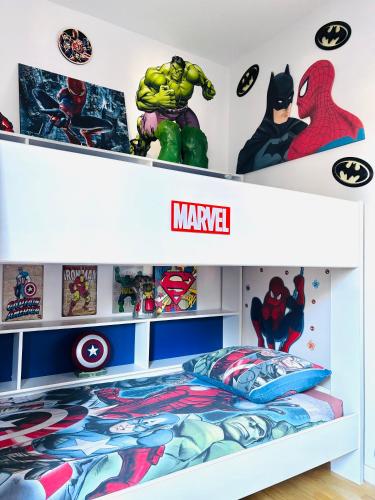a childs room with a superhero themed bedroom at THE ENCHANTED HOUSE ( 15 min walk to Disney) in Serris