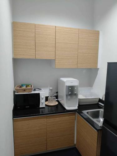 a kitchen with a counter top with a toaster and a microwave at The sea forest 101 in Rayong
