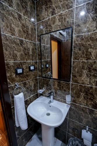 a bathroom with a sink and a mirror at Imperial Pyramids View Inn in Cairo