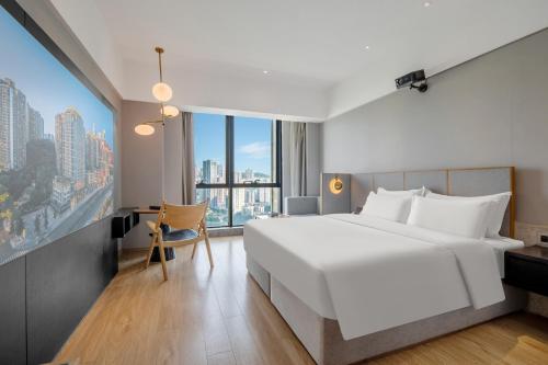 a hotel room with a large bed and a desk at Chongqing From Hotel in Chongqing
