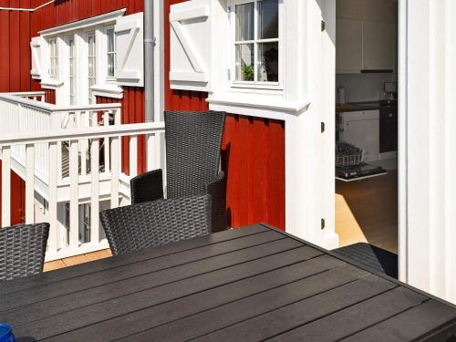 a table and chairs on the balcony of a building at Seaside Escape in Bagenkop - By Traum Ferienwohnungen in Bagenkop