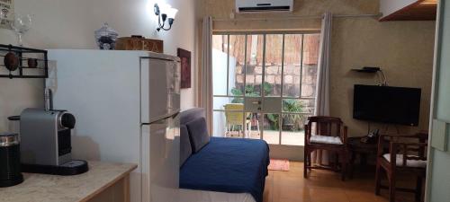a kitchen with a refrigerator and a table and a window at Love & Lemons in Yesod Hamaala