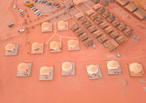 an overhead view of a group of buildings on an orange floor at Catalina Luxury rum camp in Wadi Rum