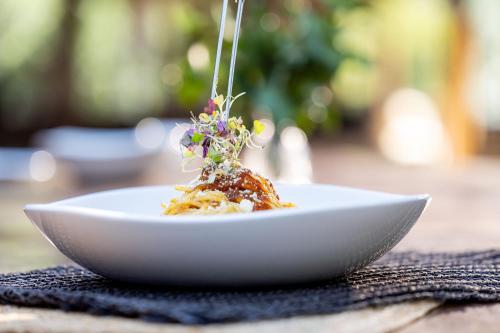 a white bowl of food on a table at Karongwe - River Safari Lodge in Hoedspruit