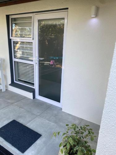 an open door to a patio with a potted plant at Garden flat Durbanville - with Office, WiFi and secure gated parking in Eversdal