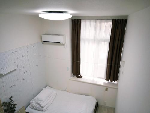 a small room with a bed and a window at D Regalo - Vacation STAY 10830v in Tokyo