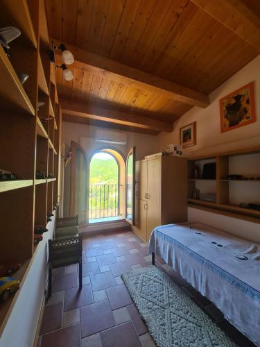 a bedroom with a bed and a large window at Residenza Magister in Serramonacesca