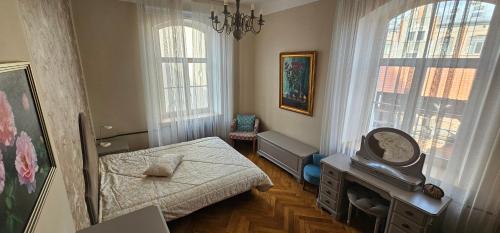 a bedroom with a bed and a tv in it at Al Pacino Family Lux Apartment in Rīga