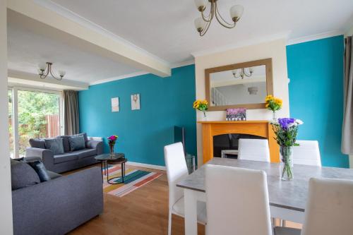 a dining room with blue walls and a table and chairs at 40 Percent Off Monthly, Large House, Free Parking in Sheldon