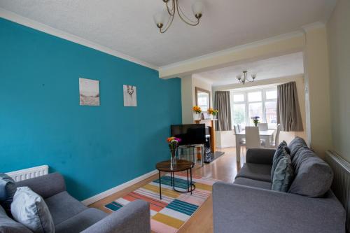 a blue living room with two couches and a table at 40 Percent Off Monthly, Large House, Free Parking in Sheldon