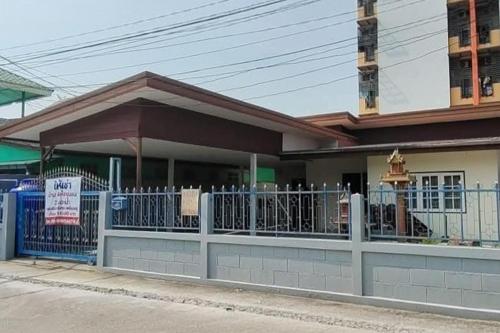 a building with a fence in front of it at JT Place Buriram in Buriram