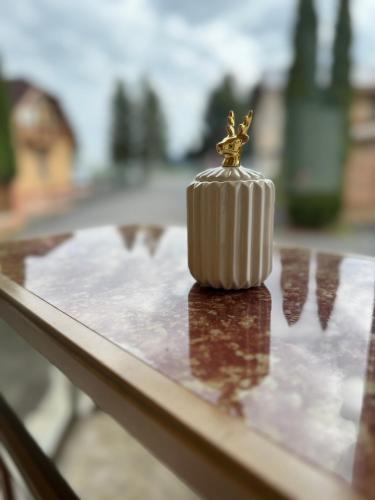 a small gold figurine sitting on top of a table at Marianna Apartman in Szentgotthárd