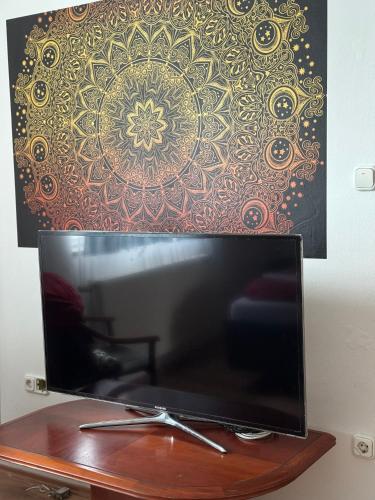 a flat screen tv sitting on top of a wooden table at Marianna Apartman in Szentgotthárd