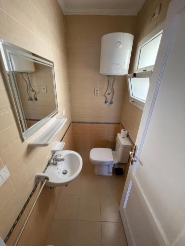 a small bathroom with a toilet and a sink at Modern Comforts Await! Spacious 2BR 2Bath w Free WiFi Stylish Furniture in Madinaty