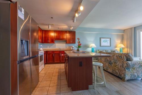 a kitchen and living room with a couch and a table at Laketown Wharf Condo beach view in Panama City Beach