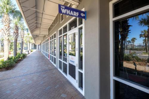 a walkway outside of a building with a sign that reads the where at Laketown Wharf Condo beach view in Panama City Beach