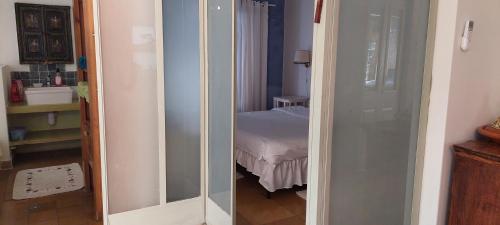 a room with a mirror and a bedroom with a bed at Love & Lemons in Yesod Hamaala