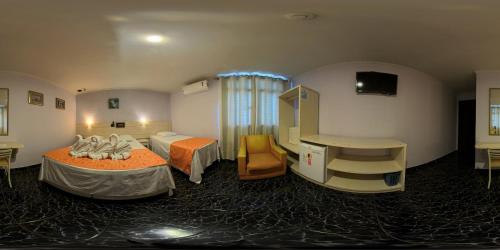 a hospital room with two beds and a window at Hotel Três Fronteiras in Foz do Iguaçu