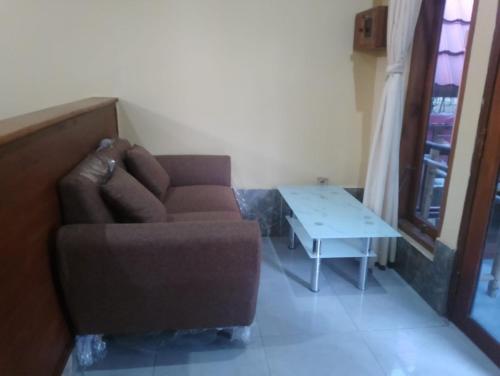 a living room with a couch and a table at Noby Gili Cottages in Gili Meno