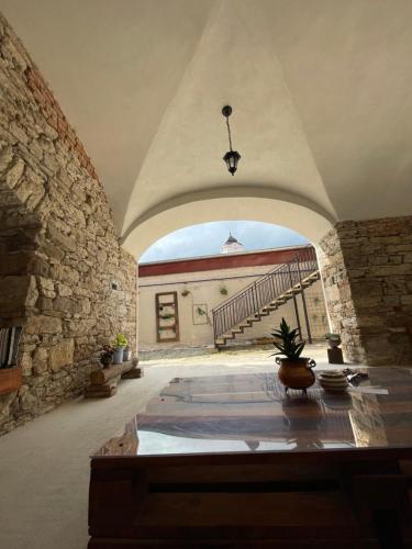 a large room with a stone wall and an archway at Alipoint Apartments in Spišské Podhradie