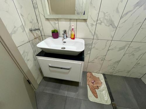 a bathroom with a white sink and a mirror at Seabreeze haven apartment in Mombasa