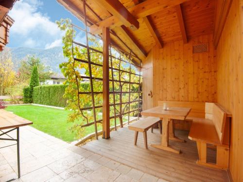 a patio with a bench and a large window at Chalet in Reith near Ski Slopes in Reith im Alpbachtal