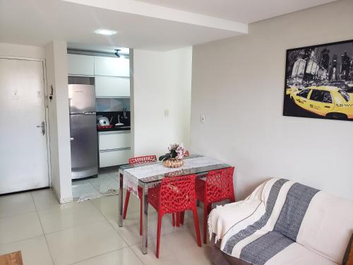 a living room with a table and a couch at Refugio Executivo Litoral in João Pessoa
