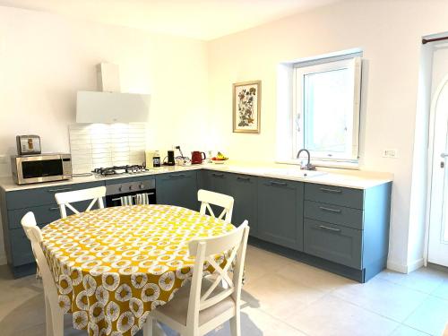 a kitchen with a table and a sink and a stove at Casa Gallina in Introdacqua