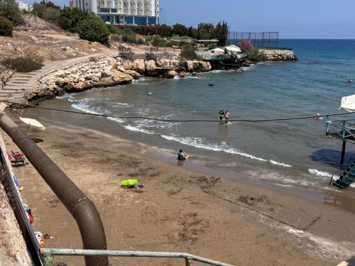 a group of people standing in the water on a beach at Çakıl suit otel restaurant in Merdivenlikuyu