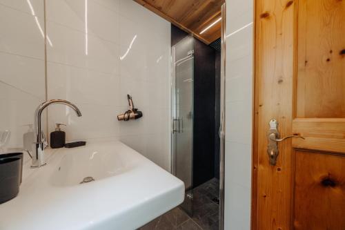 a bathroom with a white sink and a shower at Appartment Ganahl in Gaschurn