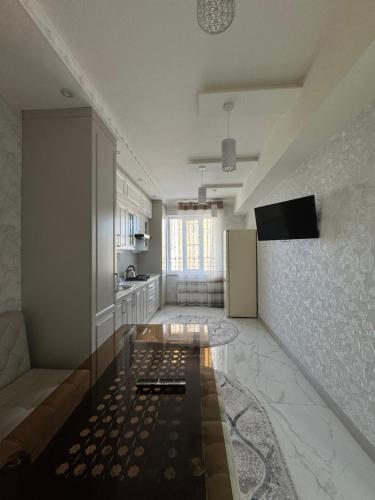 a living room with a couch and a table at Samarkand Central Luxury Apartment in Samarkand