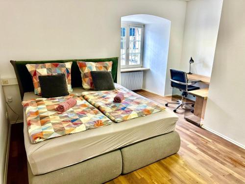 a bed in a room with a desk and a desk at Apartment 2 in Stockach
