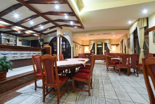 a dining room with a table and chairs at Vila Mina in Zlatibor