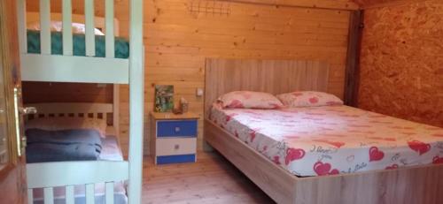 a bedroom with two bunk beds in a cabin at Bujtina Liqeni i Shkopetit in Madhesh