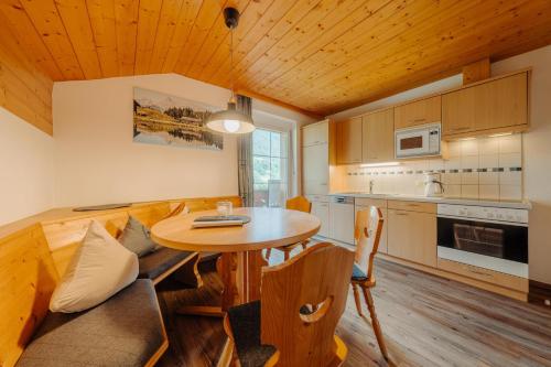a kitchen with a table and chairs in a room at Appartment Ganahl in Gaschurn