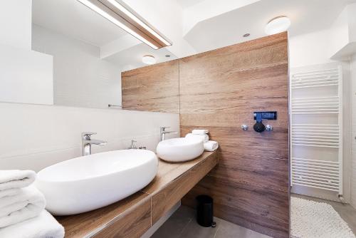 a bathroom with a white tub and a sink at Villa Krasica - Private Tennis Court, Sauna & Jacuzzi in Krasica