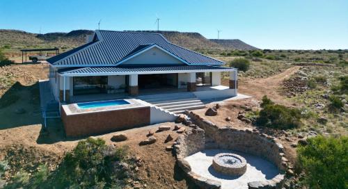 an aerial view of a house with a swimming pool at Leeuwkuil Lodge in Philipstown