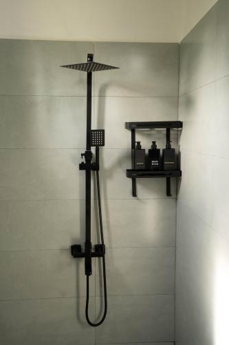 a shower with an umbrella on a wall at Villa Zenora Hikkaduwa in Hikkaduwa