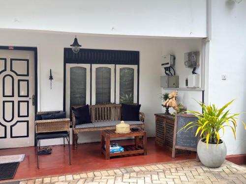 a living room with a couch and a table at Selyna Sky Terrace in Kandy