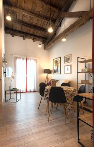 a living room with a table and chairs and a dining room at Barchessa Rossetti in Concordia Sagittaria