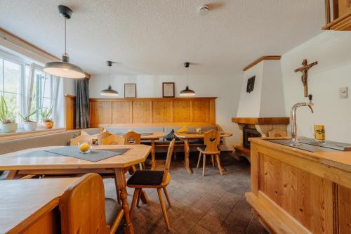 a kitchen with wooden tables and chairs and a dining room at Appartment Ganahl in Gaschurn