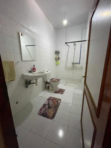 a bathroom with a toilet and a sink at Youness House in Aourir