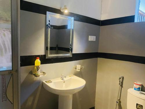 a bathroom with a sink and a mirror at Kavee Waves Hiriketiya in Dickwella