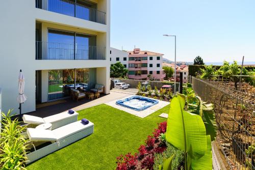 a view of a house with a yard with a garden at Star Lit Jacuzzi Apartment in Câmara de Lobos