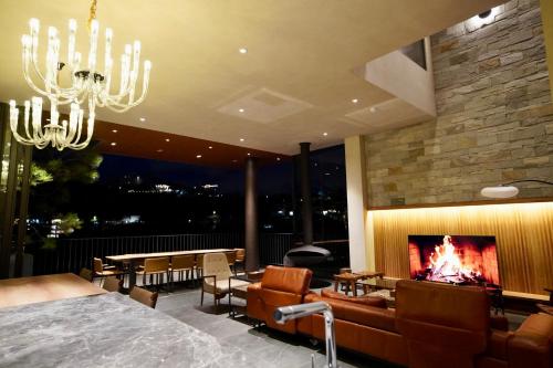 a living room with a fireplace and a couch at Là Yên Villa - Đà Lạt in Ấp Ða Lợi