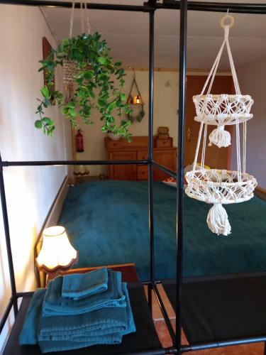 a bedroom with a black bed with a green bedspread at OUDenTEAK in Euscheid