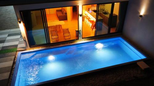 a large swimming pool in the middle of a room at Sunrise Resort & Cafe - ซันไรส์ รีสอร์ท & คาเฟ่ in Nakhon Phanom