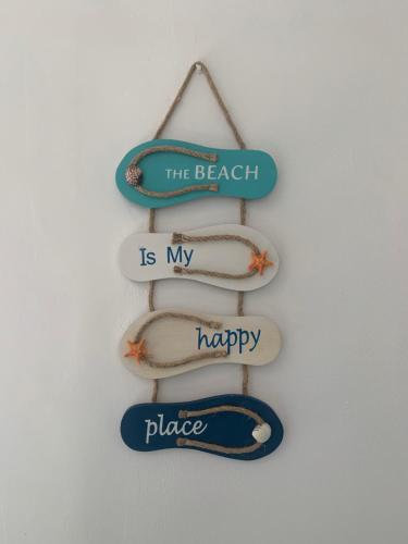 a sign that says the beach is my happy place at Il terrazzino sul Golfo in Recco