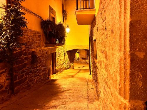 an alley in an old town at night at Ca la Bet in Claravalls