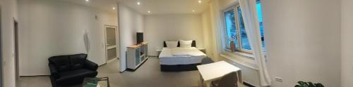 a bedroom with a bed and a chair in a room at Ecke's Apartment in Hüllhorst